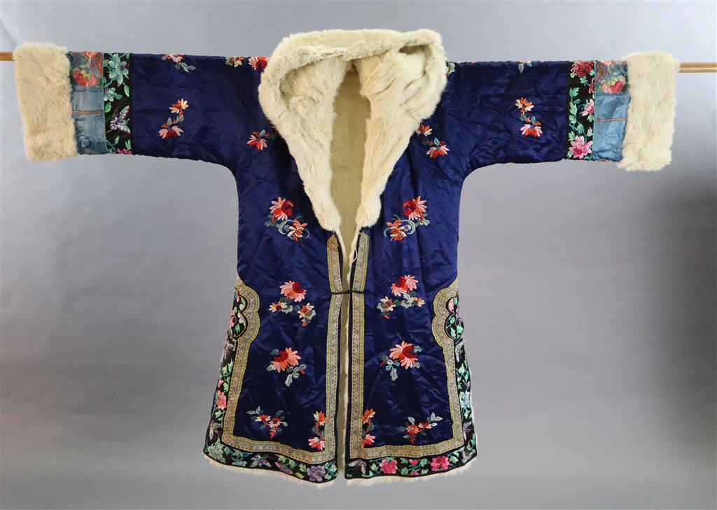 A Chinese blue silk multicoloured embroidered Chinese winter robe, early 20th century, with a white fur lining, length 108cm